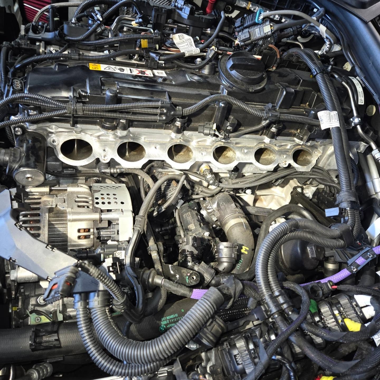 Our actual BMW service bay with professional equipment and BMW vehicle