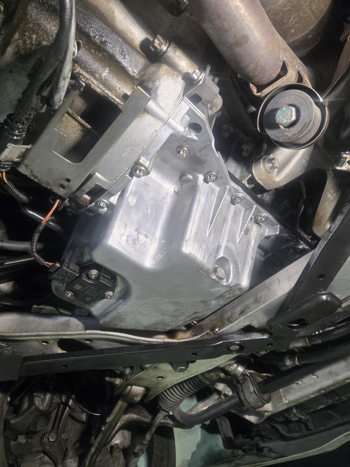 Close-up of a transmission oil pan during underbody service
