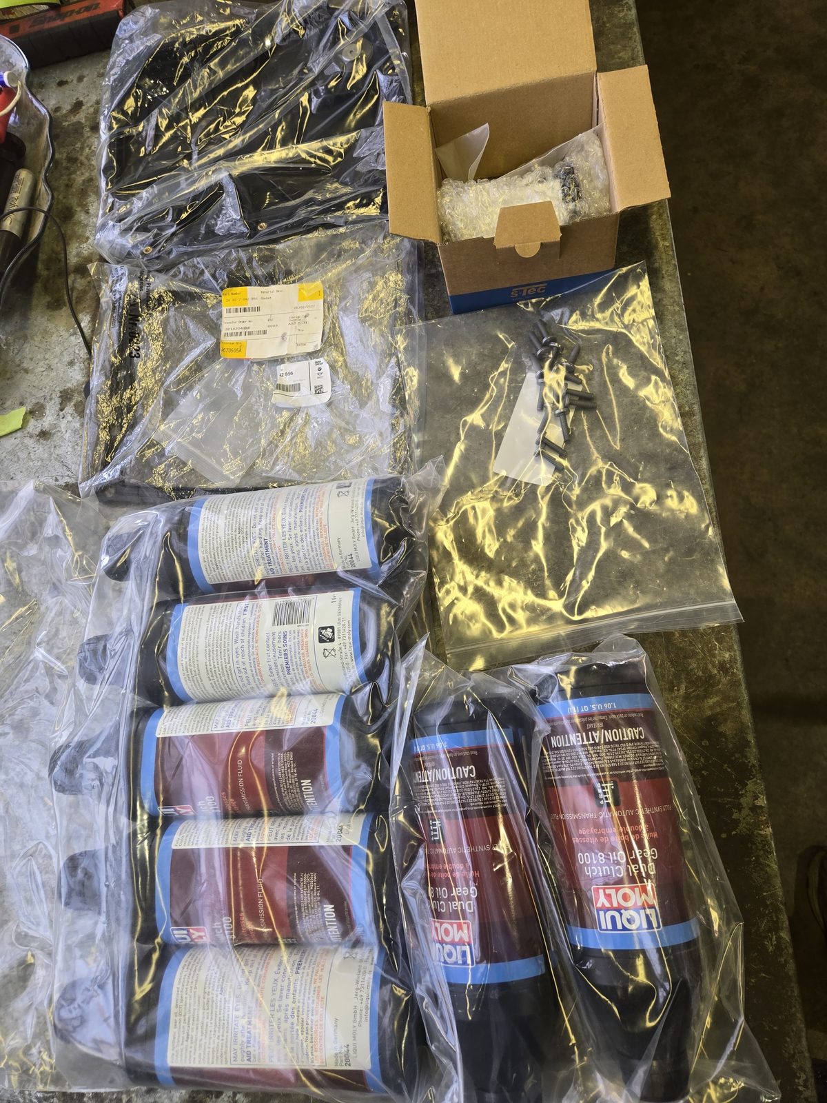 Liqui Moly dual-clutch transmission fluid and genuine BMW parts on the bench