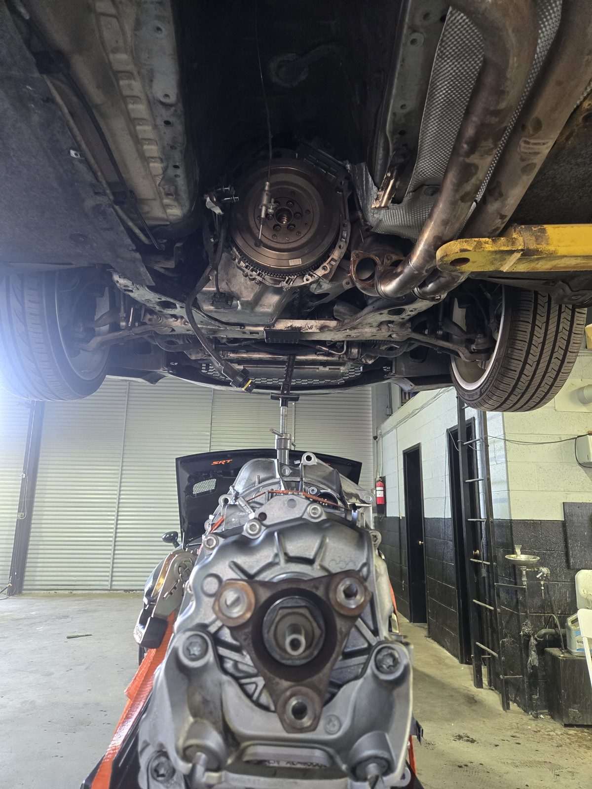 Transmission and transfer case removed from underneath a vehicle on a lift